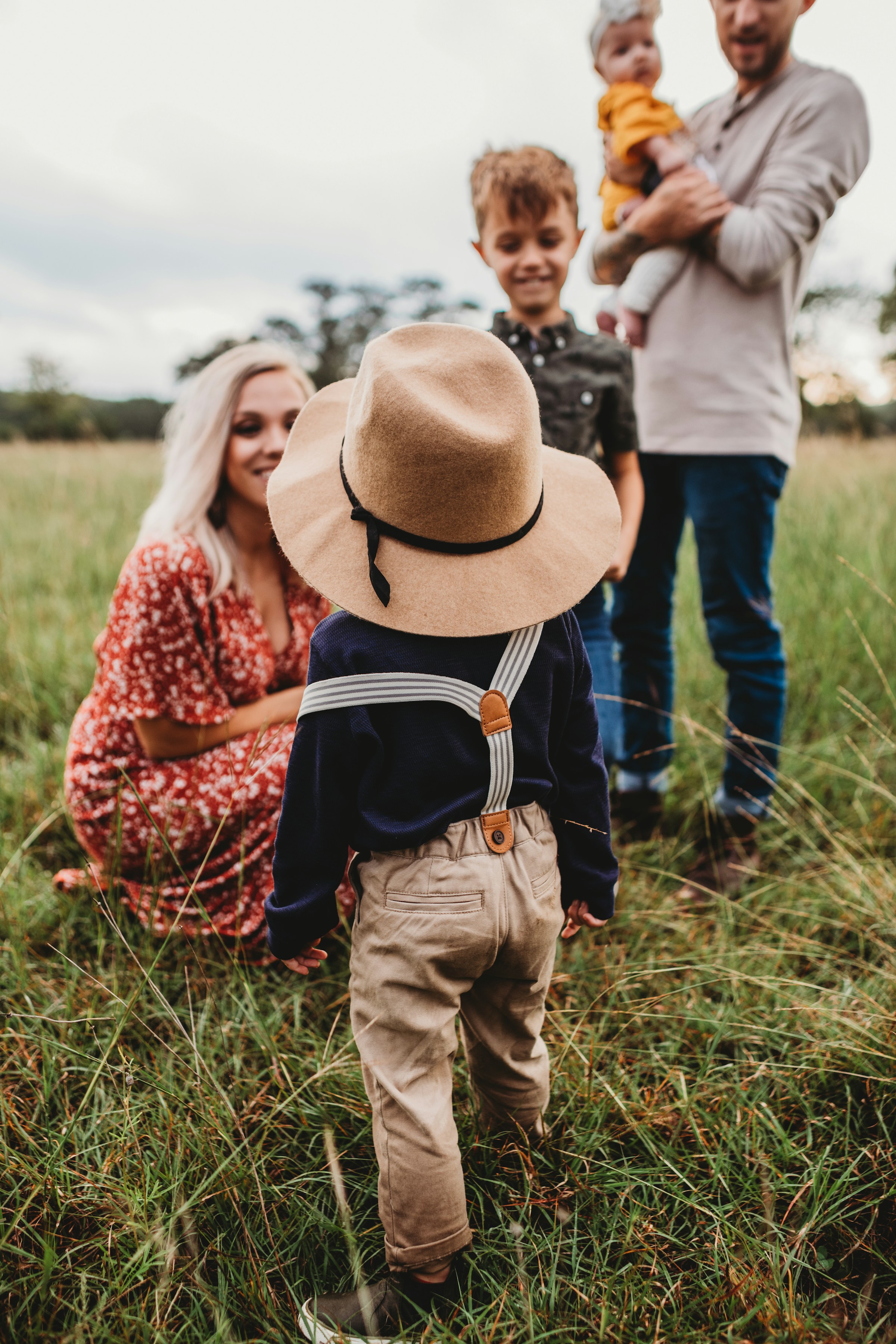 A parent walking outdoors with a young child.